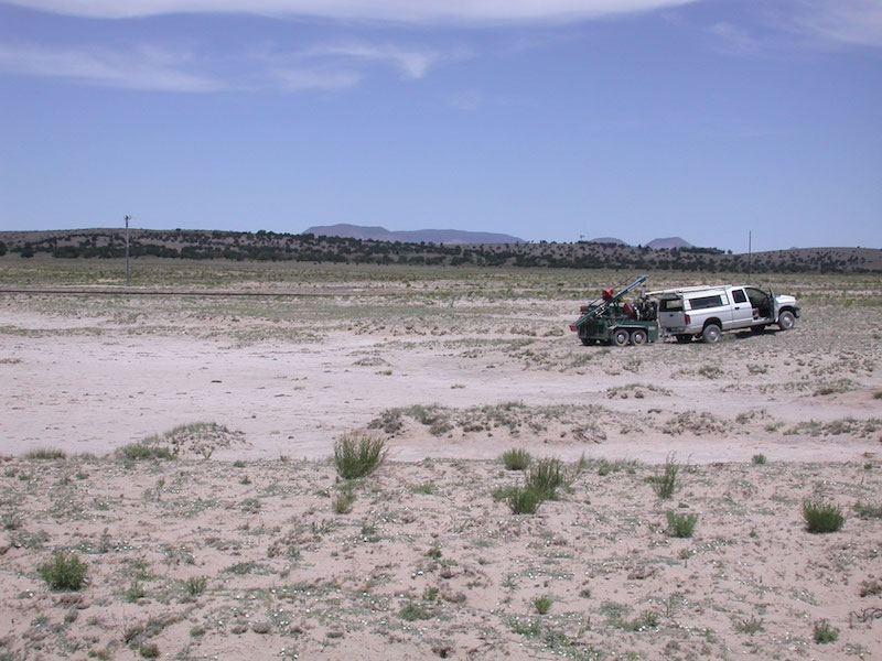 The Ake Folsom site in 2004. The truck is up on the flank of the 2105m shoreline. The southwest track of the VLA is visible in the middle distance. The 1978 excavations were in and along the margins of the flatter, eroded area. (V.T. Holliday).